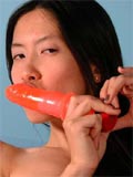Thin asian enjoys a dildo in her shaved pussy