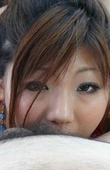 Pretty and flat chested Asian babe giving a nice footjob